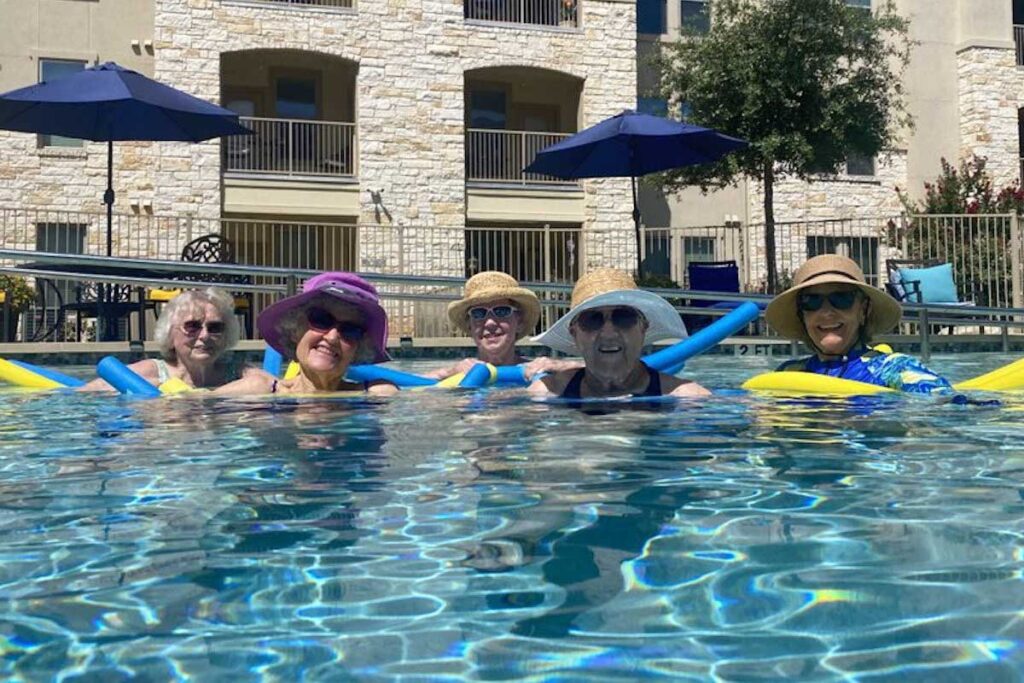 Civitas Senior Living | Senior social group enjoying outdoor pool