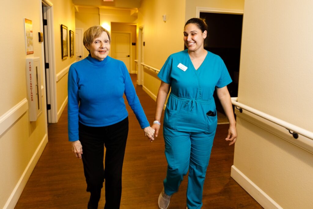 Civitas Senior Living | Caretaker and senior holding hands