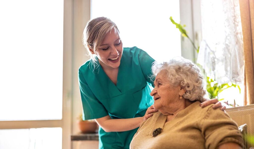 StoneCreek of Edmond | Caregiver helping senior woman with dementia