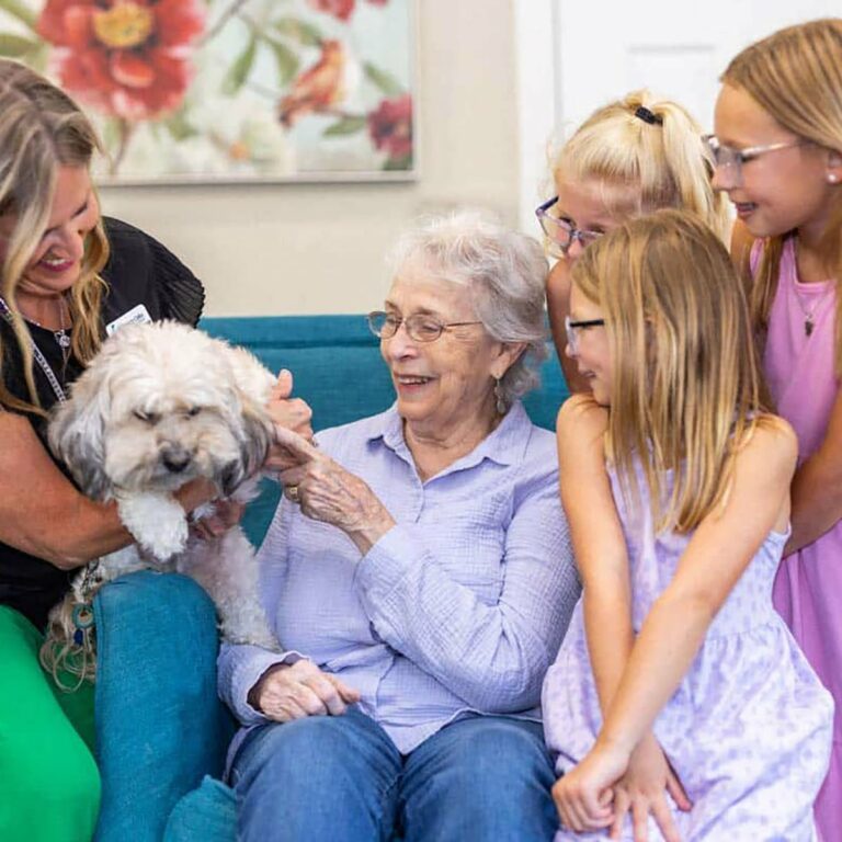 Stonecreek of Edmond | Memory care residents petting dogs