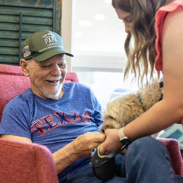 Civitas Senior Living | Senior resident petting a dog