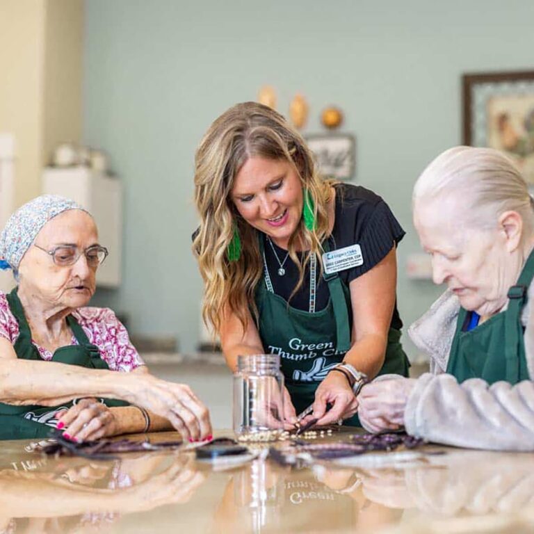 Civitas Senior Living | Senior residents crafting with caregiver