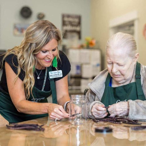 Civitas Senior Living | Senior resident craftingwith caregiver