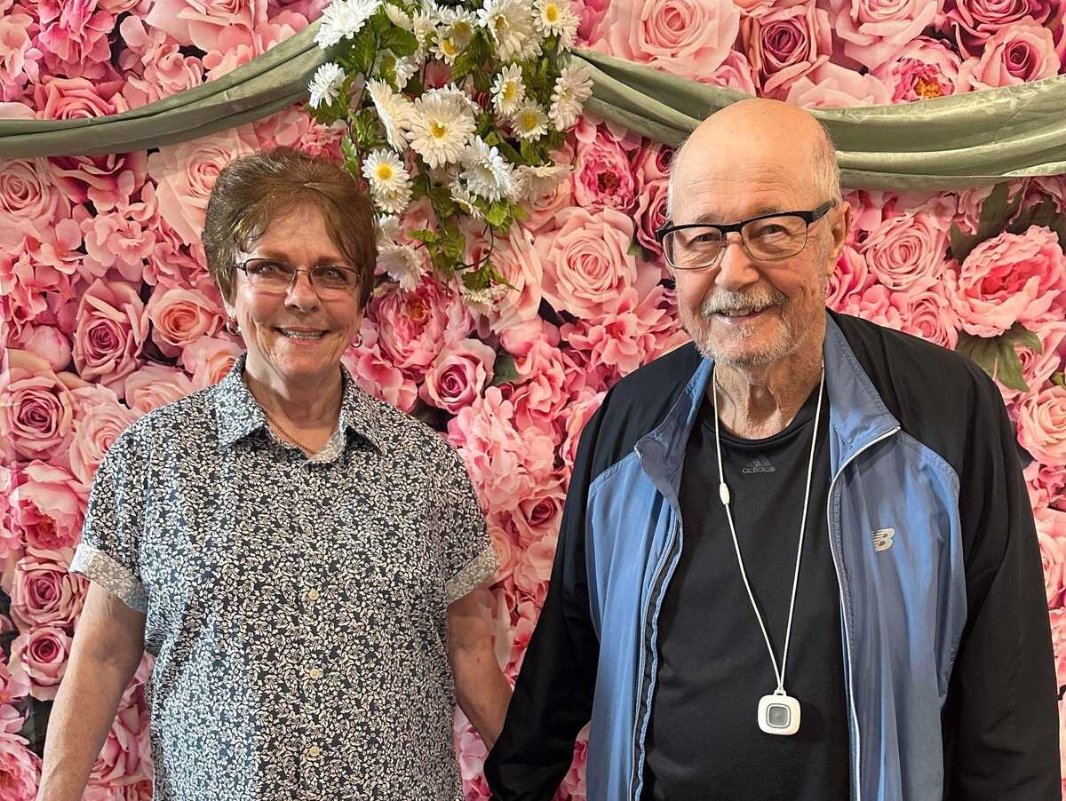 The Ridglea | Couple in front of flowers