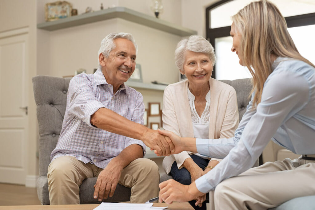 The Grand | Happy senior man sealing with a handshake their next move for retirement