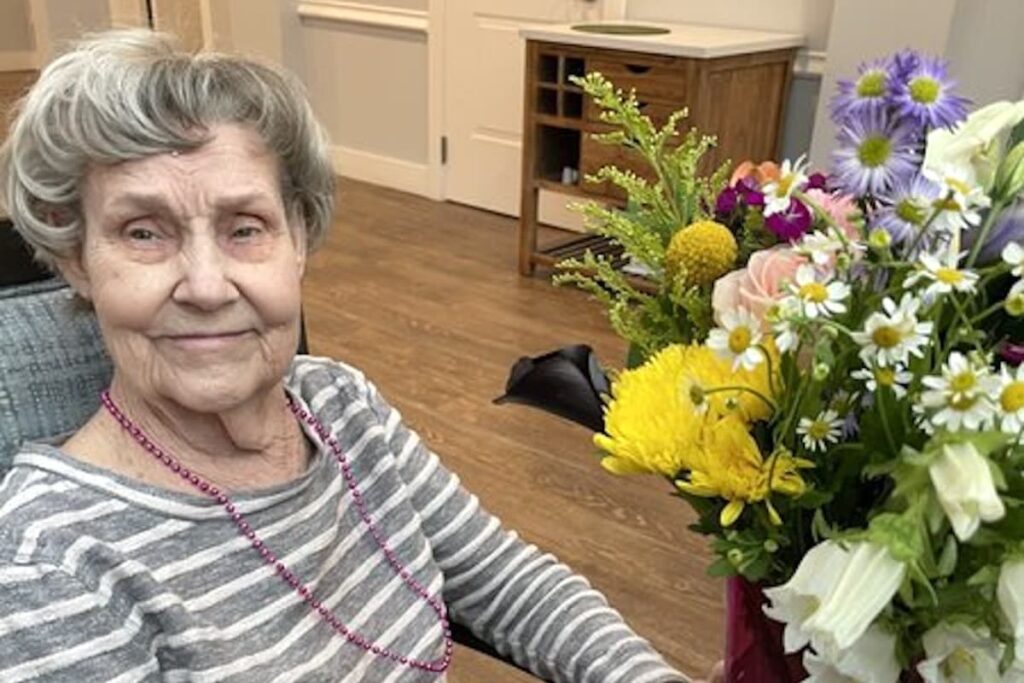 Stonecreek of North Richland Hills | Resident with her flowers