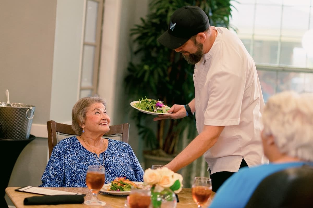 Civitas Senior Living | Senior living chef serving fine dining to a senior resident