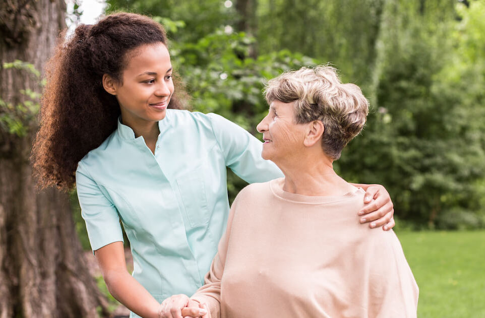 The Grandview of Chisholm Trail | Senior woman and her caregiver standing outside