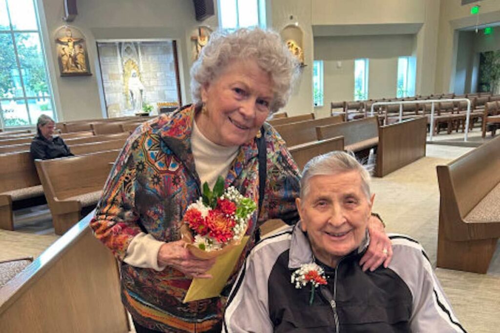 The Grand Senior Living | Couple holding flowers to commemorate their 70th wedding anniversary