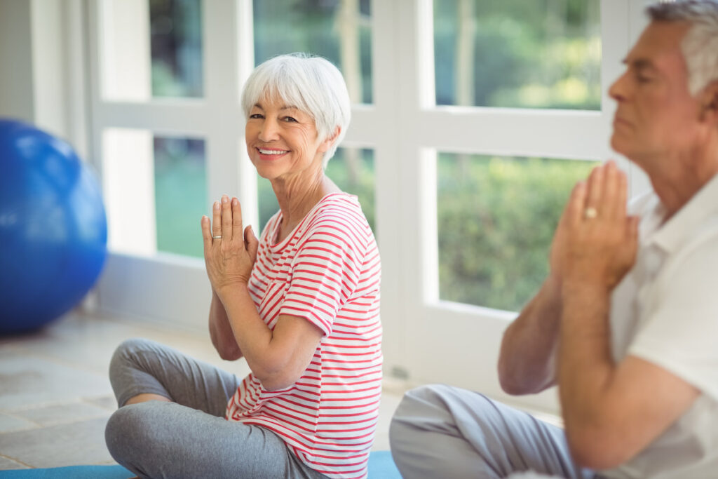 The Grand | Senior woman meditating and smiling